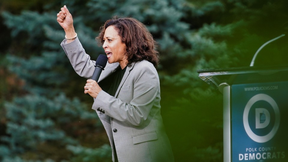 California Senator Kamala Harris speaks to a crowd with her arm raised at Polk County Democrats’ Steak Fry in Des Moines, Iowa in September.