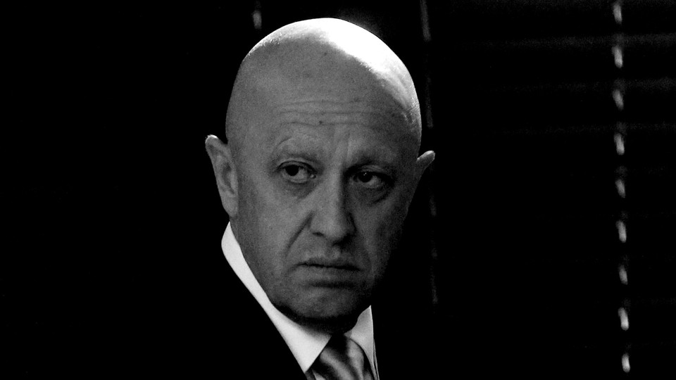 Black-and-white photo of Yevgeny Prigozhin, a bald man in a suit
