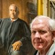 Picture of Harlan Crow in front of a painting of Justice Clarence Thomas