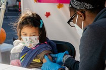 A child receiving her second dose of Pfizer's COVID-19 vaccine in December