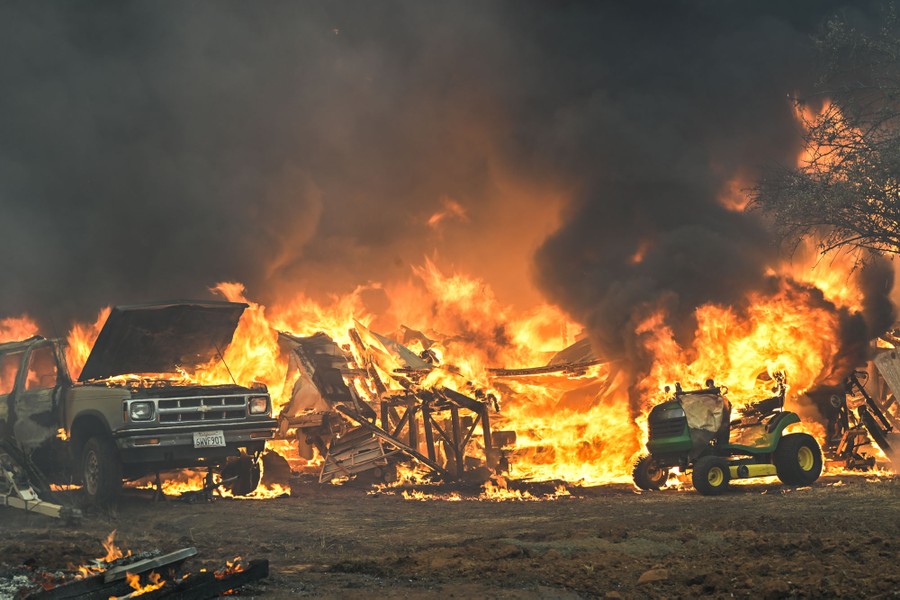 At least one building, as well as a truck and a riding mower, go up in flames.
