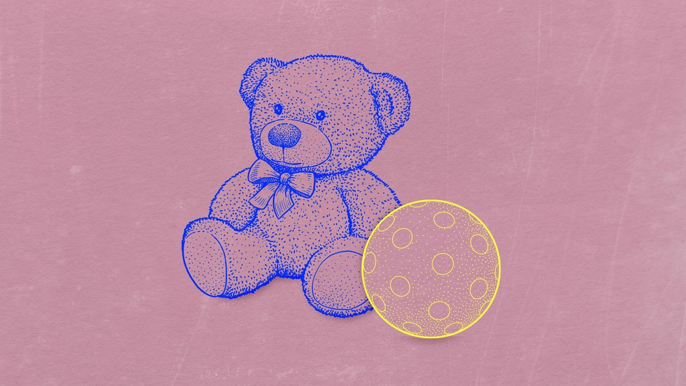 A teddy bear alone with a ball