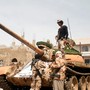 Pro-government fighters gather next to a tank they use in the fighting against Houthi fighters in the southwestern city of Taiz, Yemen, on March 22, 2017.