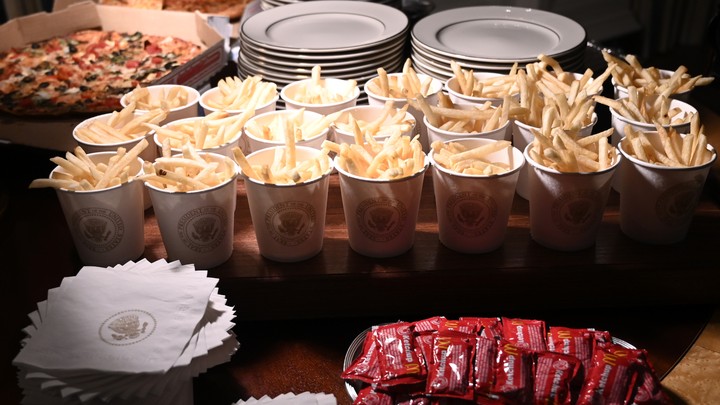 Pizza and french fries on a table in the White House