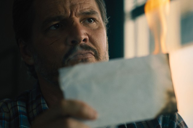 Pedro Pascal reading a burned piece of paper