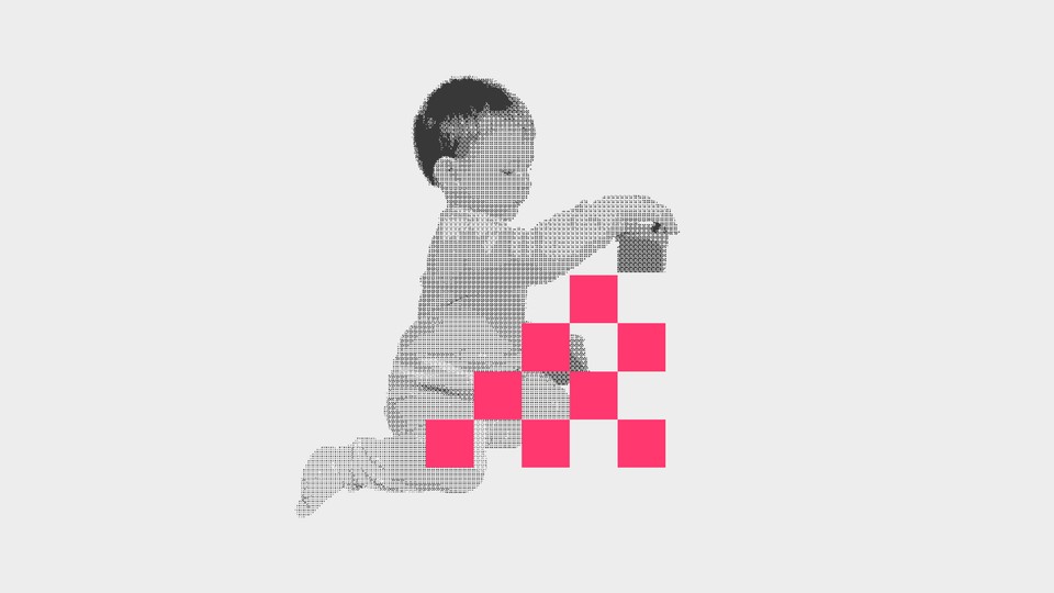 A baby stacks digital blocks