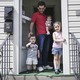 Mohammad Zkrit and three of his four children stand on the porch of their newly-rented home in Erie, Pennsylvania. The family fled the ongoing civil war in Syria and have been resettled in the United States.