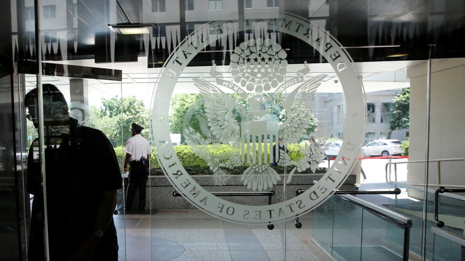 The State Department's logo on a glass door