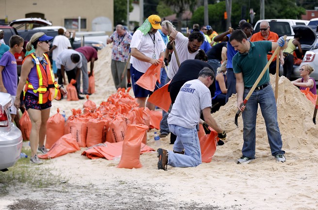 Orlando city employees and volunteers fill sandbags for residents as they prepare for Hurricane Irma, Friday, Sept. 8, 2017, in Orlando, Florida.