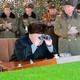 North Korean leader Kim Jong Un guides a firing contest among multiple launch rocket system batteries.