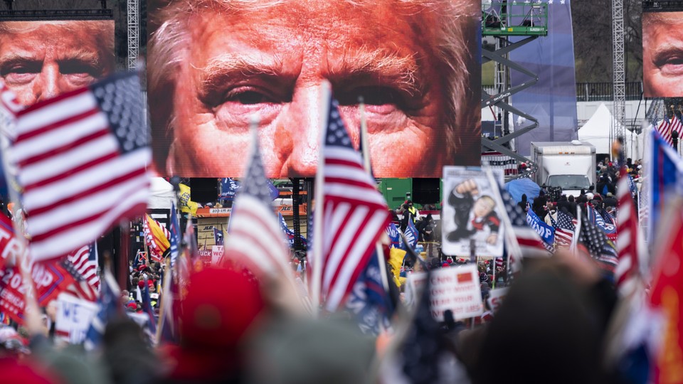 An image of President Donald Trump appears on video screens before his speech to supporters from the Ellipse at the White House in Washington on Wednesday, Jan. 6, 2021