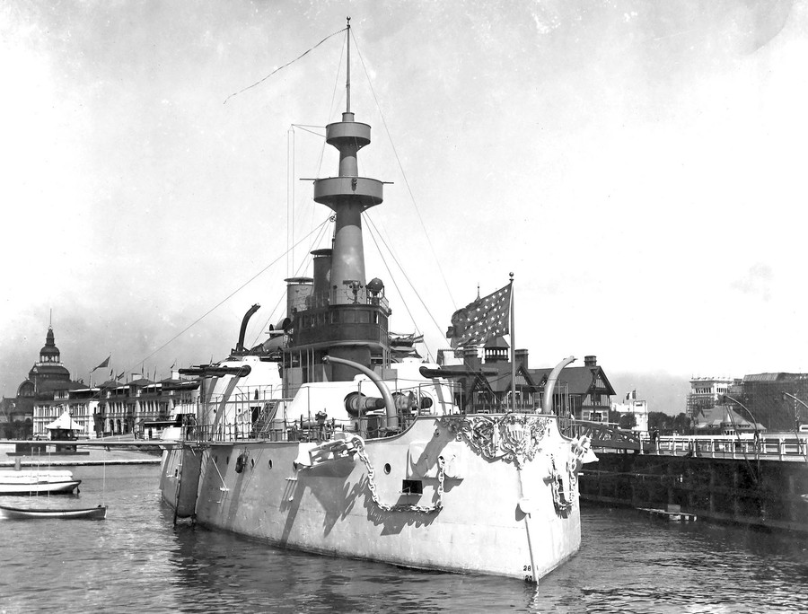 A full-scale replica battleship "docked" beside a pier