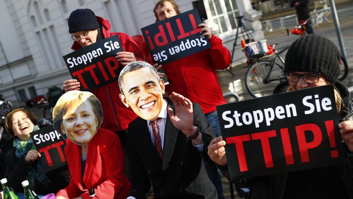 Protesters wear masks of U.S. President Barack Obama and German Chancellor Angela Merkel as they demonstrate against the TTIP in Hanover in April.