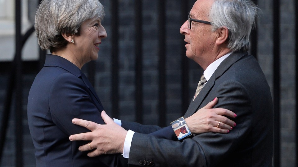 British Prime Minister Theresa May welcomes European Commission President Jean-Claude Juncker to Downing Street in London on April 26.