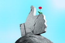 Giant rock thumb with a flower growing out of it