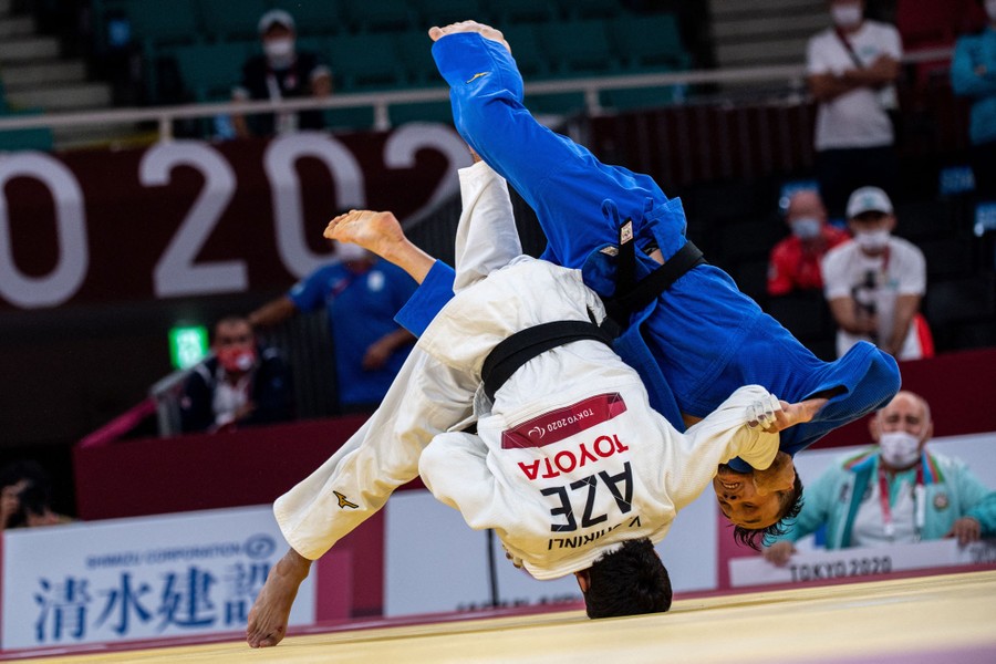 Two men grapple during a judo match.