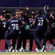 A photo of Team USA celebrating during a game in the T20 Cricket World Cup.