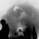 Picture showing the silhouette of a soldier next to a missile and a cloud of smoke