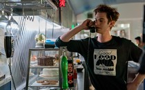 Andrew Garfield on the phone in a restaurant kitchen in "Tick, Tick . . . Boom"