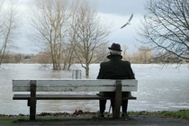 A man sitting alone on a bench