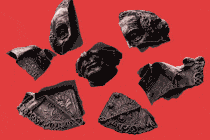 An animated illustration of broken pieces of a bust of John Macdonald, Canada's first prime minister, reforming