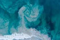 Rip tide forming a whirlpool of sand.