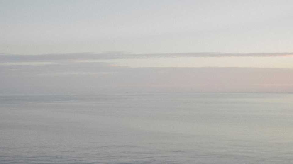 A grainy, hazy photograph of the Black Sea and Abrau Peninsula