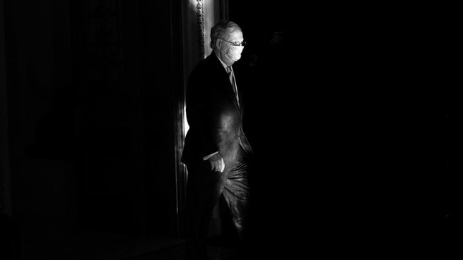 A black and white photo of Mitch McConnell in a suit 