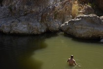 A man in a natural body of water