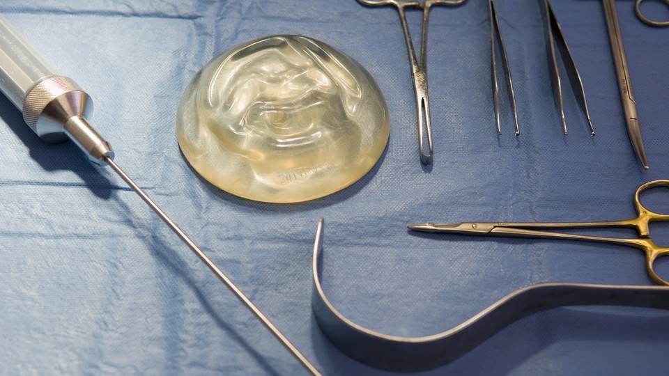 An implant sitting on a mat with surgical tools