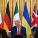 trump with flags behind
