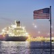 The U.S. and Polish national flags fly in the foreground as the liquefied-natural-gas (LNG) tanker Oak Spirit sits docked with Poland's first import of U.S. LNG at the Gazoport terminal in Świnoujście, Poland, on Thursday, July 25, 2019.