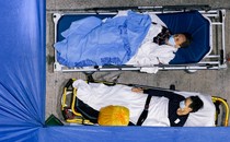 Patients sleep at a makeshift COVID-19 treatment area outside a hospital.