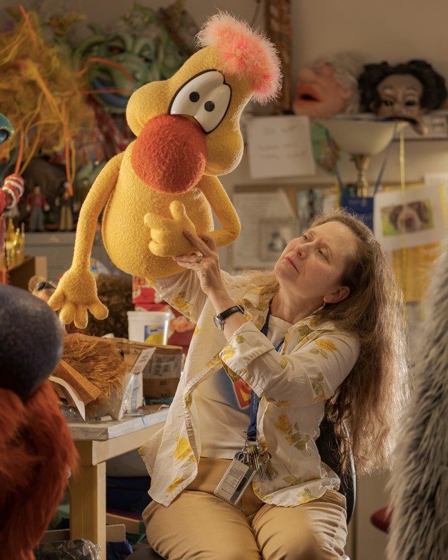 Mary McClung holds a puppet in her studio at West Virginia University