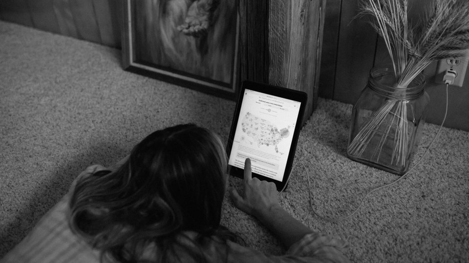 A woman scrolling through her iPad.