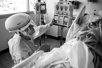 U.S. Army 1st Lt. Blaine Woodcock, a critical care nurse assigned to the 627th Hospital Center, provides care to a COVID-positive patient.