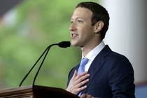 Mark Zuckerberg speaks at a podium with a hand over his heart.
