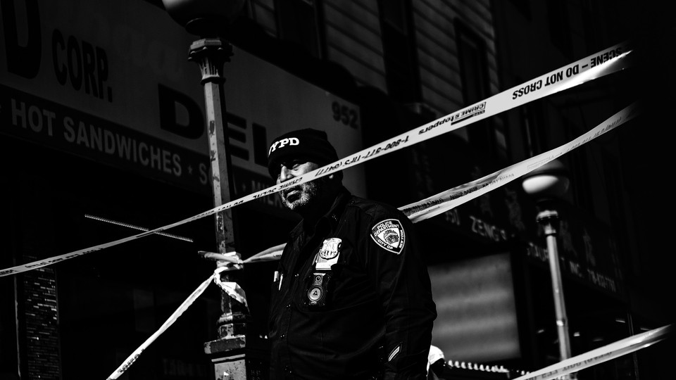 A police officer is seen outside the 36th Street subway station in Brooklyn, where 23 people were injured in an attack.