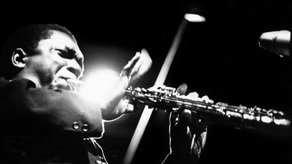 Black-and-white photo of John Coltrane performing