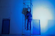 A man climbs a ladder. 