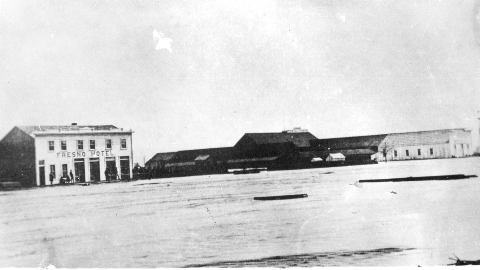 A black-and-white photograph from the 1880s shows the Fresno hotel next to the Fresno train station, the stop on the Southern Pacific Railroad around which the city would develop.