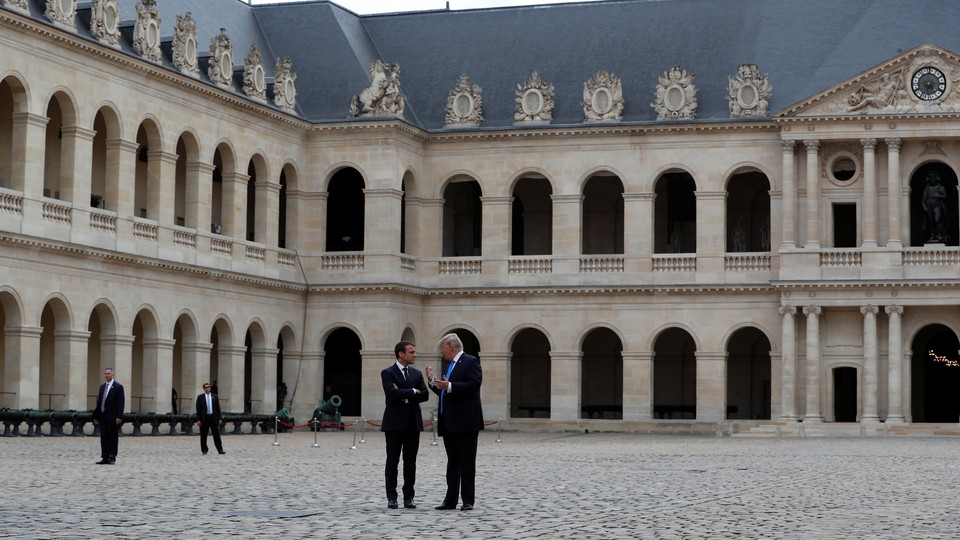 U.S. President Donald Trump talks to President Emanuel Macron of France in Paris in July.