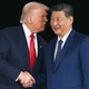 Photograph of Donald Trump and Xi Jinping shaking hands, as Trump speaks into Xi’s ear