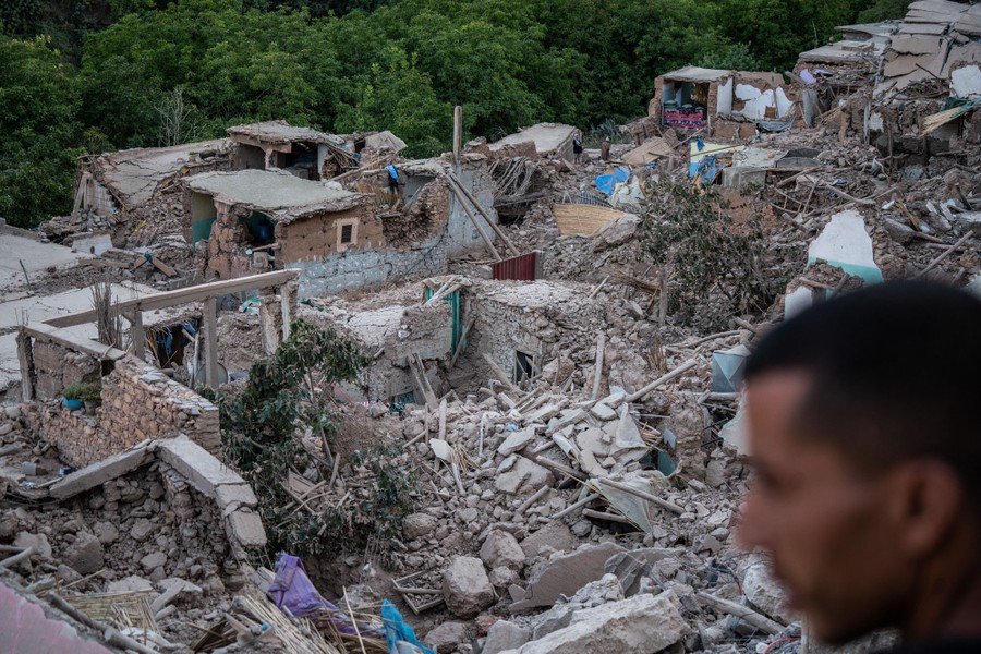 A person looks over many quake-destroyed houses.