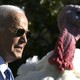 President Joe Biden stands beside a turkey during an event at the White House.