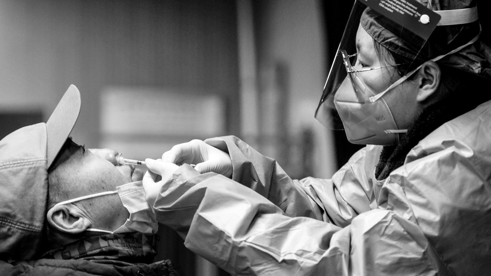 Photo of someone receiving a nasal spray vaccine in Beijing, China