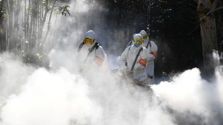 Sanitation workers disinfect a residential compound in China.