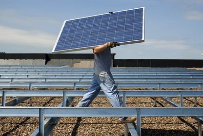 A person installing a solar panel