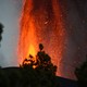 A bright orange burst of lava emerges from the ground