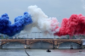 blue, white, and red plumes of smoke above a bridge over the Seine